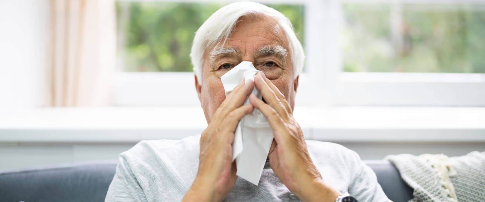 An older adult learning how allergies can affect the ears.
