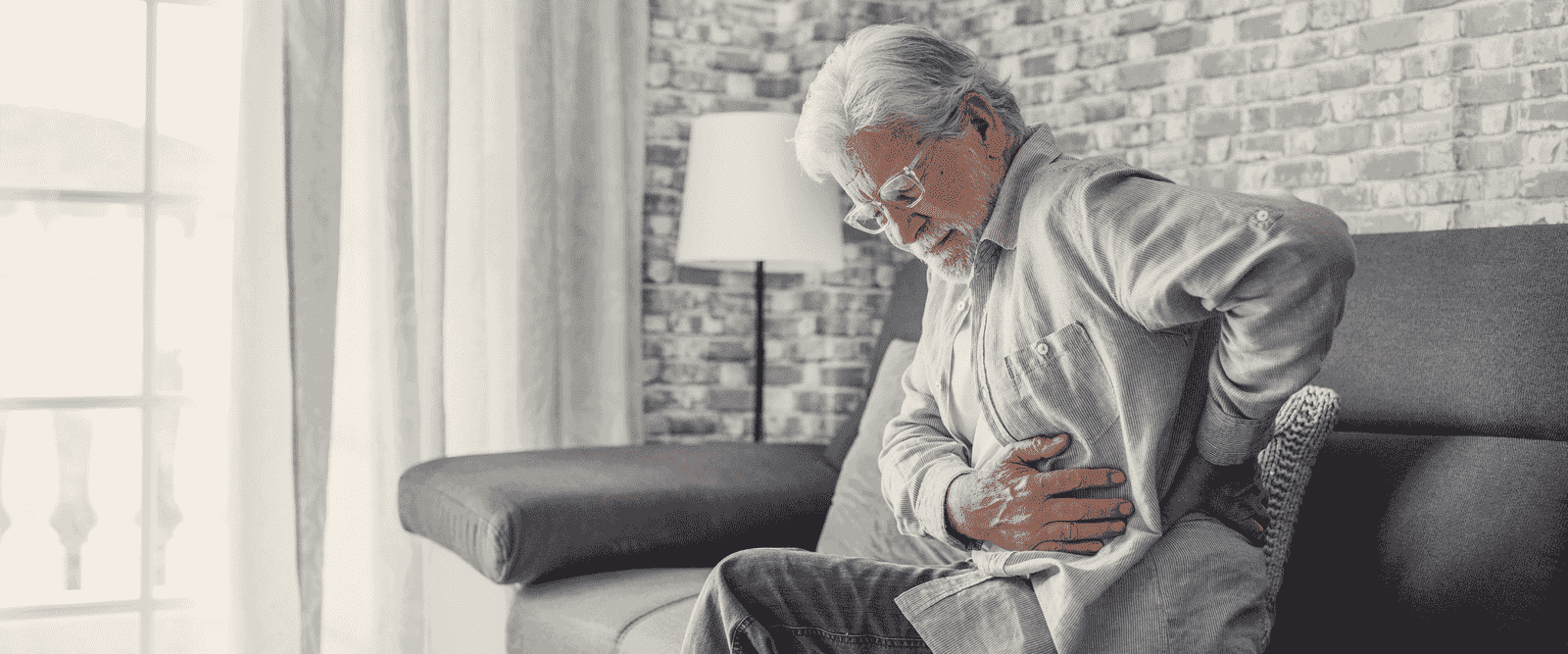 An older adult stretching to ease morning stiffness.